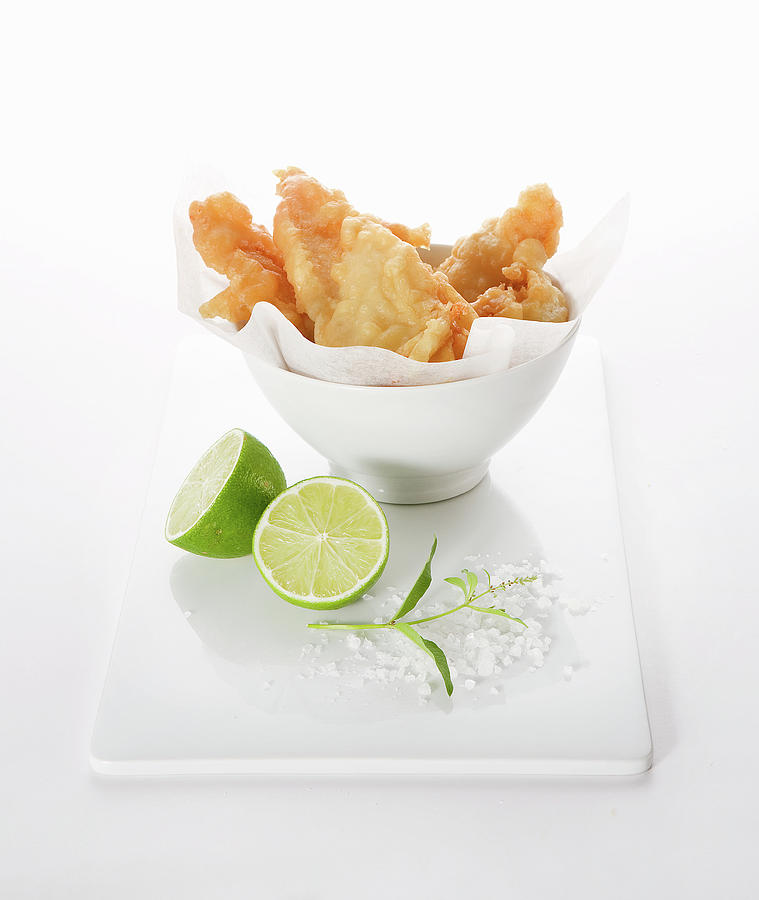 Battered Fish In A Bowl With Lime Halved, Sea Salt And Sprig Of Fresh Lime Leaves Photograph by Trudy Kelder