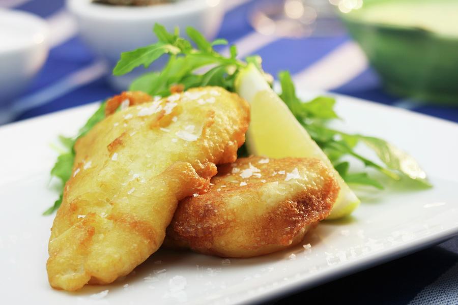 Battered Hake With Lemon, Rocket And Salt Flakes Photograph by Creative ...