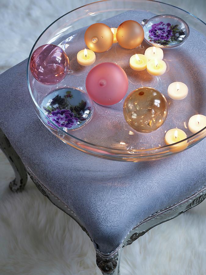 Baubles And Lit Tealights In Glass Dish On Upholstered Rococo Footstool Photograph by Matteo Manduzio