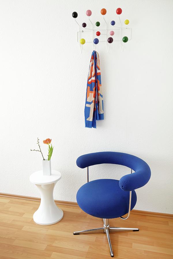 Bauhaus Swivel Chair With Blue Cover And Side Table In Front Of Classic, Wall-mounted Coat Rack Photograph by Lioba Schneider Fotodesign