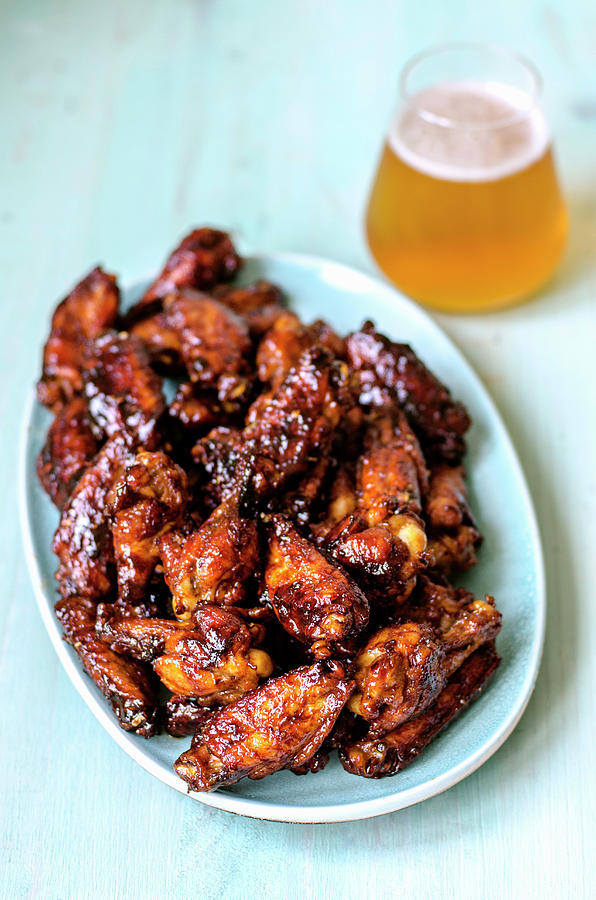 Bbq Wings, Pre-cut Into Pieces On A Blue Plate And Fresh Craft Beer Photograph by Gorobina