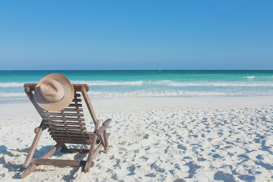Beach Chair With A Hat, On An Empty Photograph by Sasha Weleber