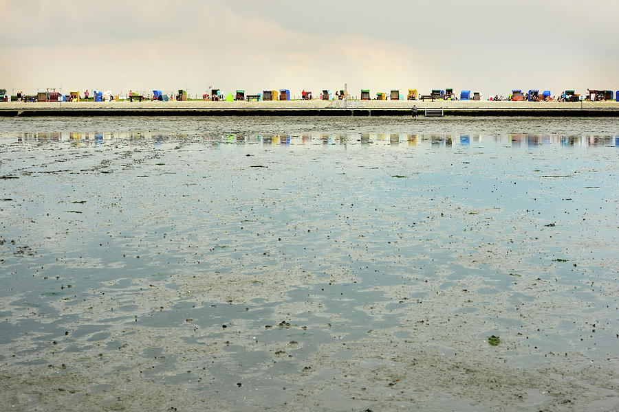 Beach Chairs Are Reflected In The Wadden Sea, North, East Frisia, Germany Photograph by Myriam Brunner