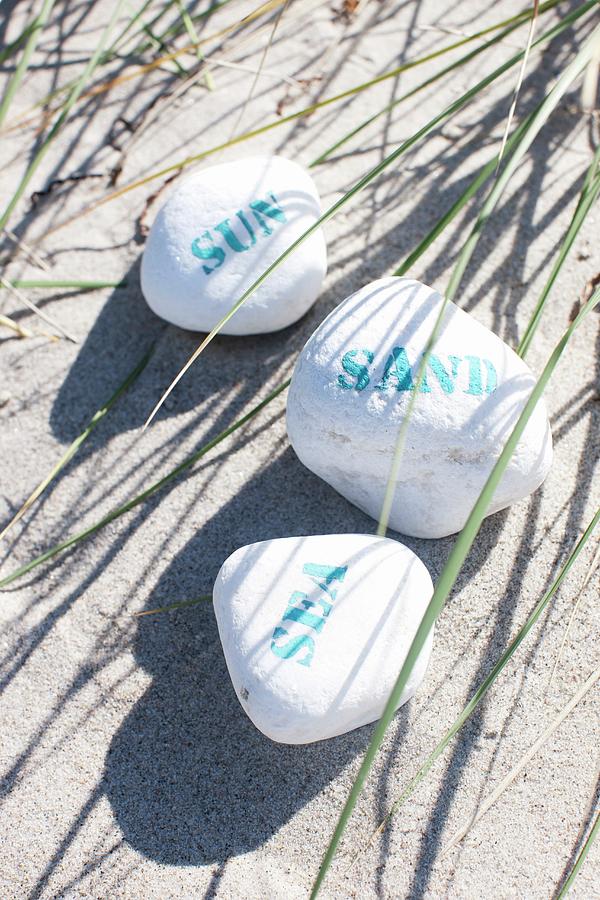 Beach Holiday - Stones With Writing Lying In The Sand Photograph by Sven Mainzer