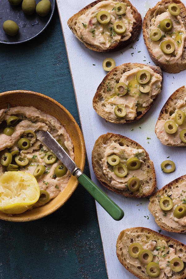 Bean And Olive Spread On Baguette, Lemon, Olive Oils, Parsley Photograph by Zuzanna Ploch
