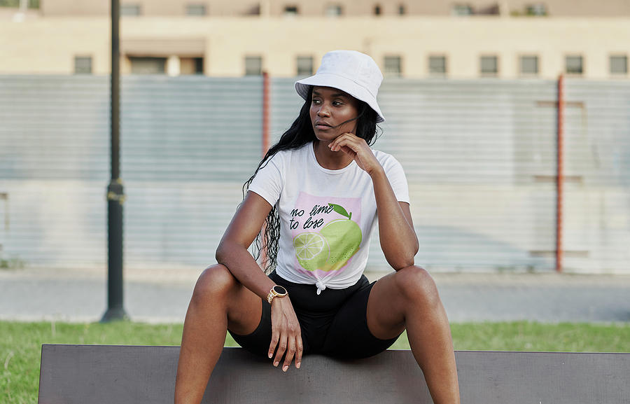 Beautiful Black Woman Looking To The Side Sitting In A Park Photograph by Cavan Images