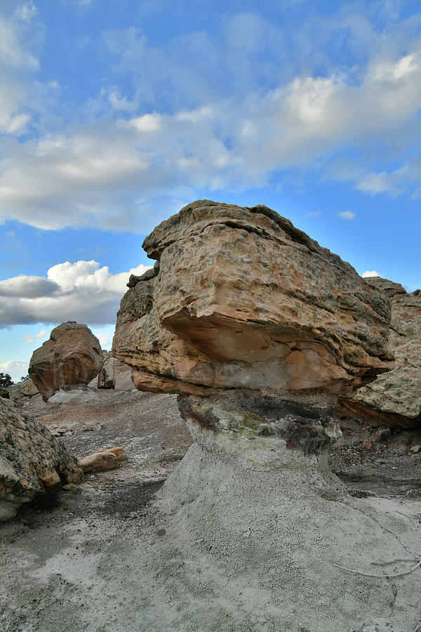 Beautiful Clouds over Bentonite Site Boulders Photograph by Ray Mathis