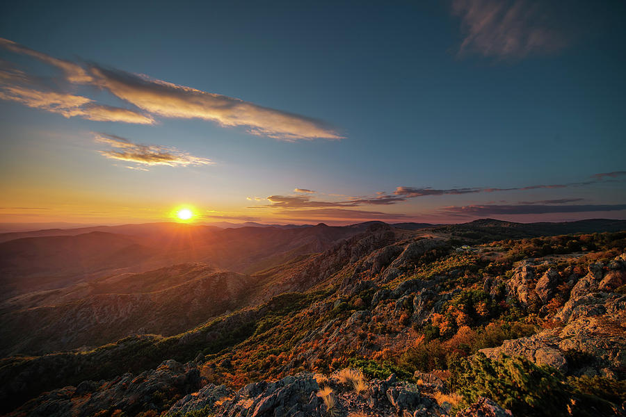 Beautiful sunset over the mountain hills and city, aerial panora ...