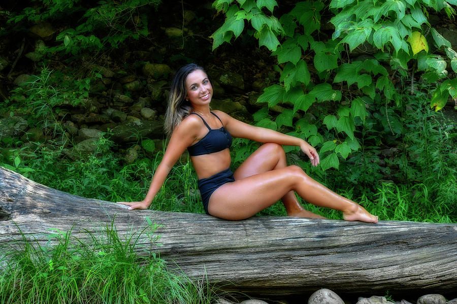 Beautiful young lady on a log in swimming suit on a log Photograph by Dan Friend