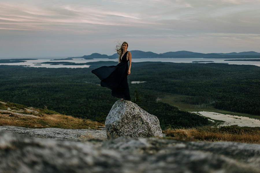 Nature Photograph - Beautiful Young Woman And Long Dress Balances On Rock On Mountaintop by Cavan Images / Chris Bennett