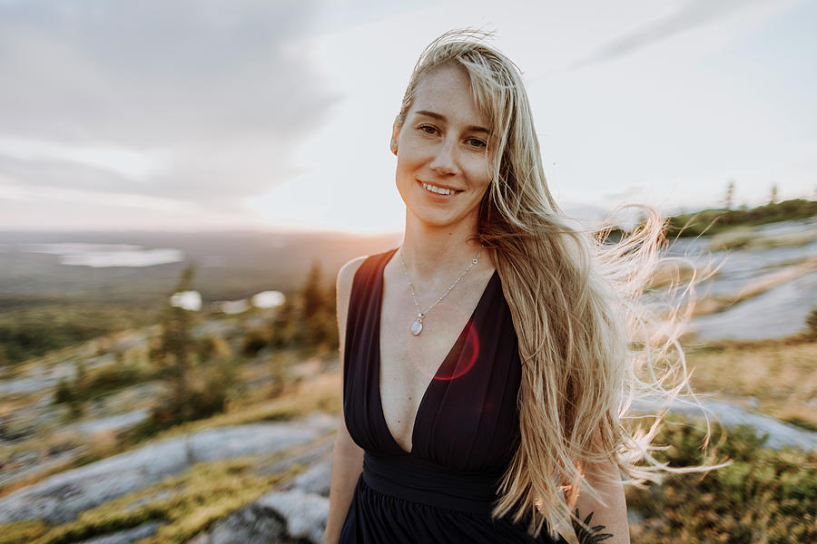 Nature Photograph - Beautiful Young Woman In Dark Dress And Long Blonde Hair Smiles by Cavan Images / Chris Bennett