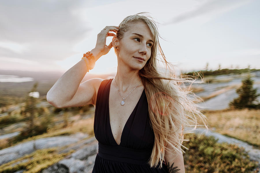 Nature Photograph - Beautiful Young Woman In Dress With Windblown Long Blonde Hair Sunset by Cavan Images / Chris Bennett
