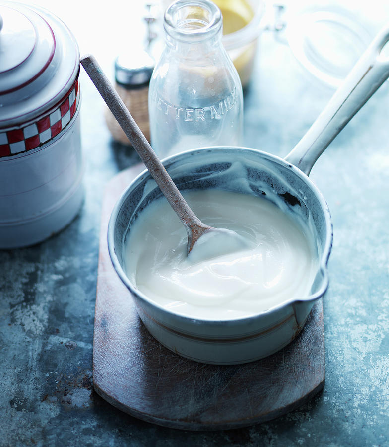 Bechamel Sauce With A Wooden Spoon In A Saucepan Photograph by Karen Thomas