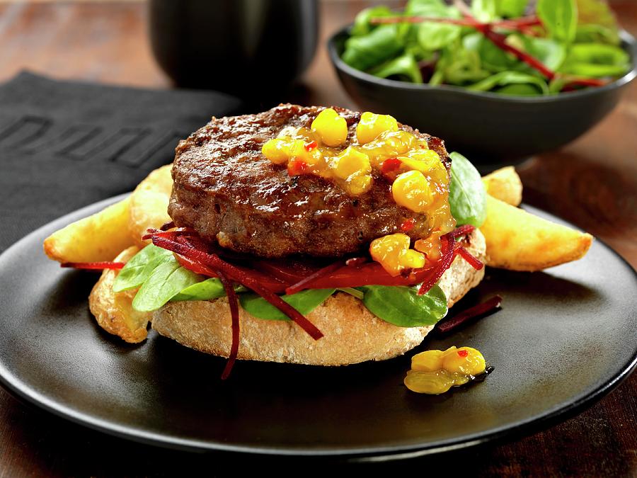 Cheese Photograph - Beef And Stilton Burger With A Sweetcorn Relish And Salad On A Ciabatta Roll by Robert Morris