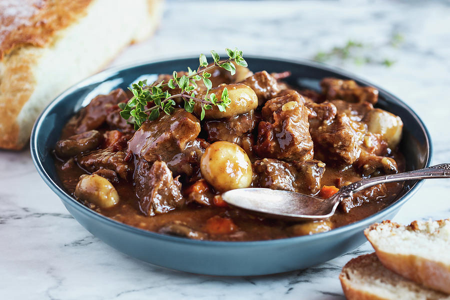 Beef Bourguignon Garnished With Fresh Lemon Thyme And Served With Homemade Artisan Bread Photograph by Stephanie Frey