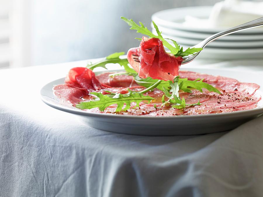 Beef Carpaccio With Pepper And Rocket Photograph by Ludger Rose