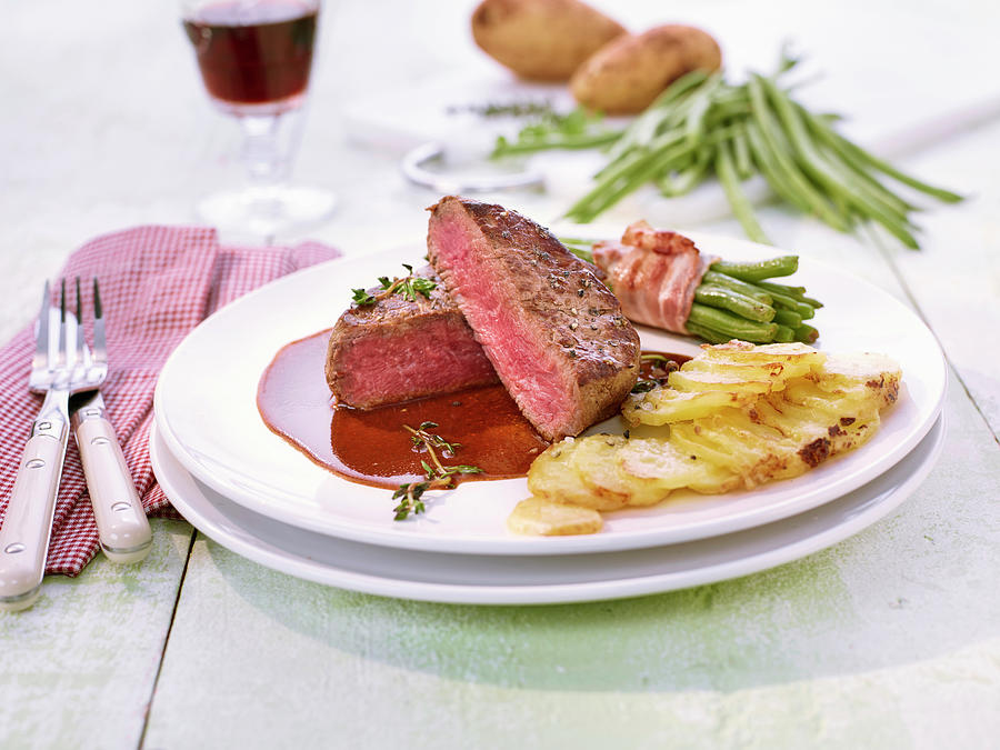 Beef Fillet With Bacon-wrapped Beans And Potato Gratin Photograph by Peter Rees