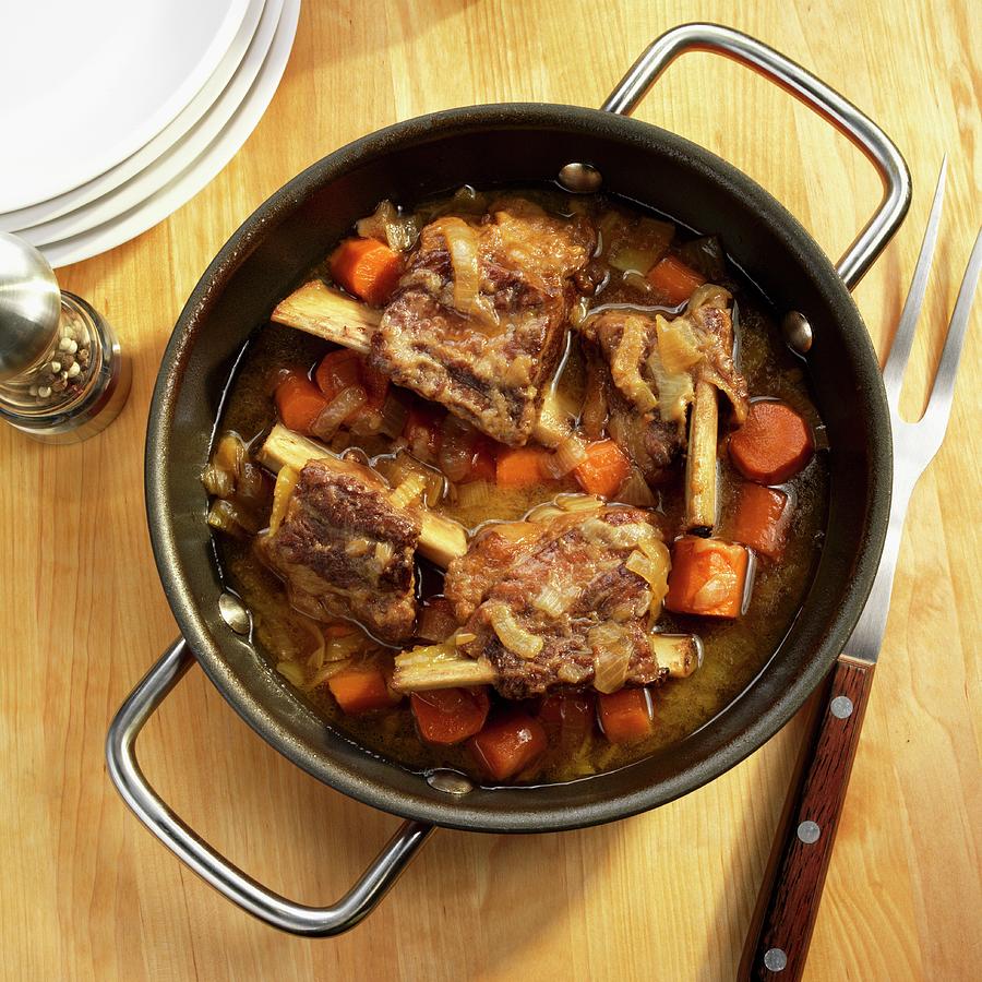 Beef Ribs Braised In Beer With Carrots, Onions And Celery In A Pot Photograph by Paul Poplis
