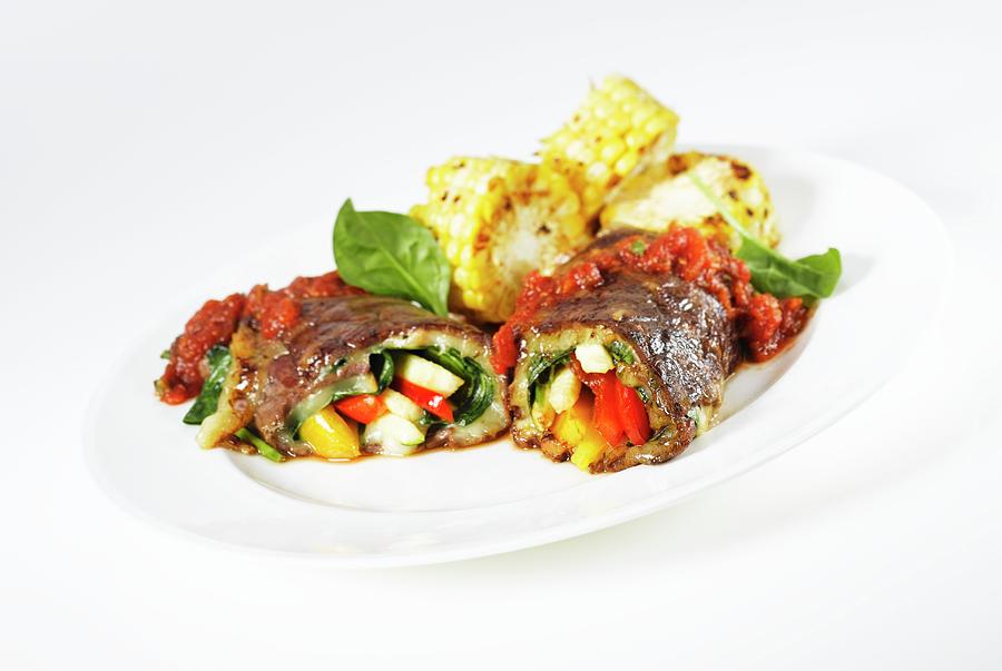 Beef Roulade Filled With Vegetables, Tomato Sauce And Grilled Corn Cobs Photograph by Glenn Moores