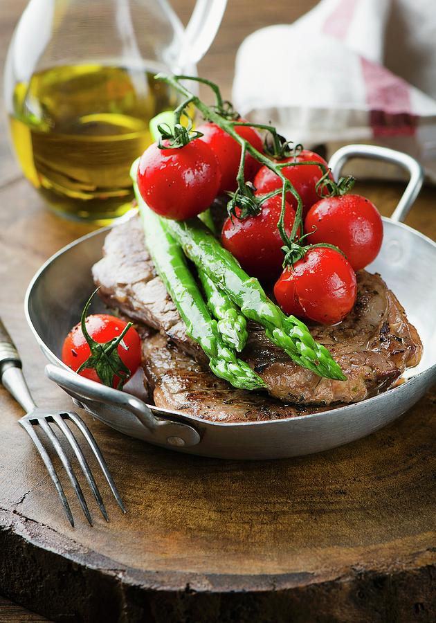Beef Steak With Asparagus And Tomatoes Photograph by Ewgenija Schall