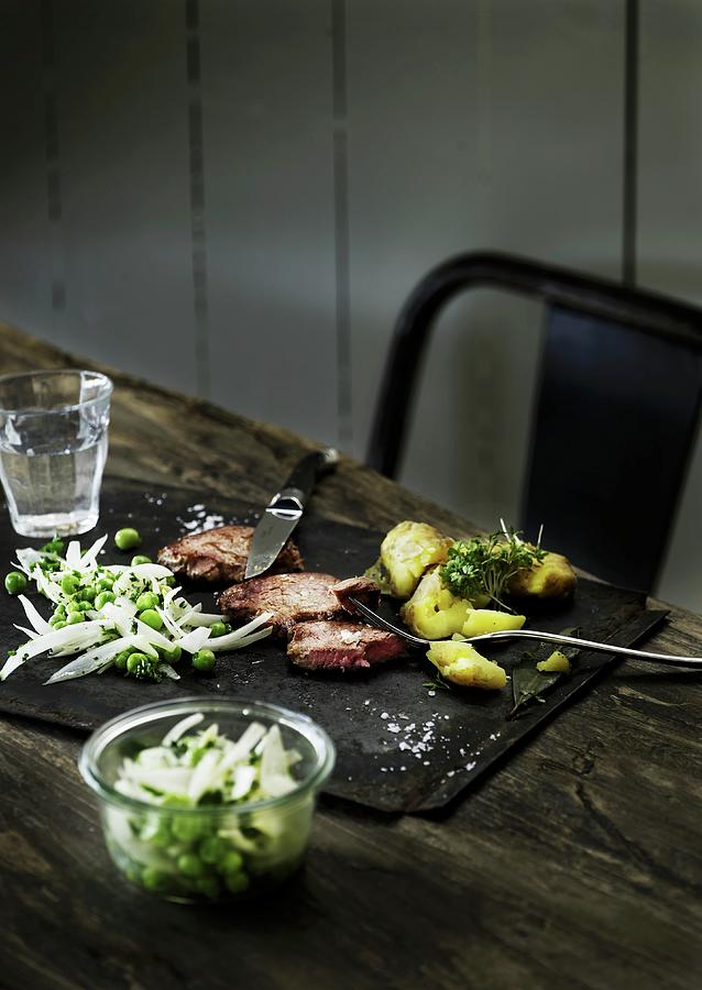Beef Steak With Potatoes And A Pea Salad Photograph by Mikkel Adsbl