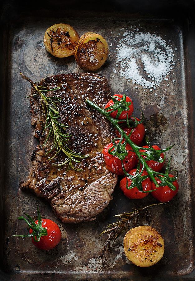 Beef Steak With Tomatoes And Rosemary Photograph by Ewgenija Schall