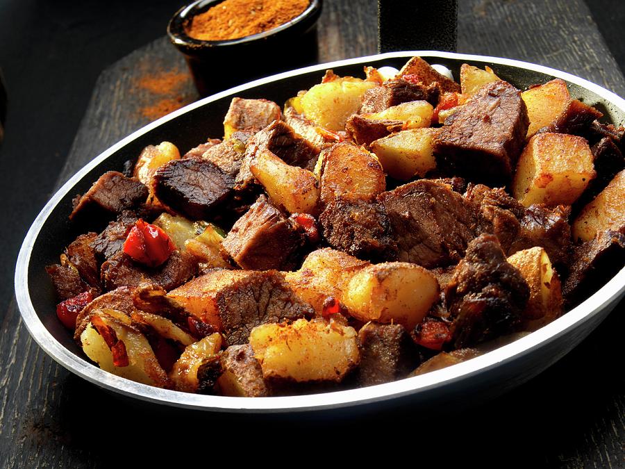 Beef With Potatoes, Onions And Cajun Spices Photograph by Paul Poplis
