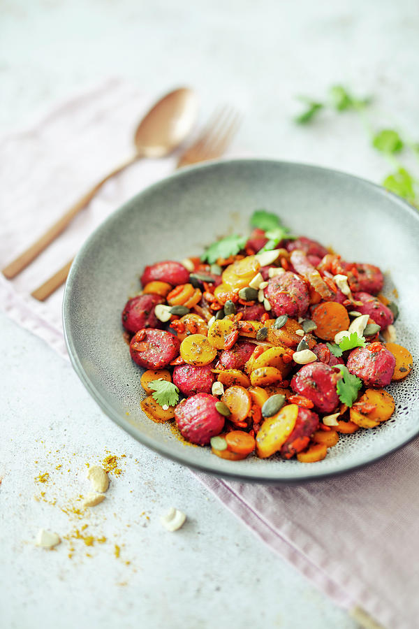 Beetroot Gnocchi With Curry, Carrots, Cashews And Goji Berries Photograph by Jan Wischnewski