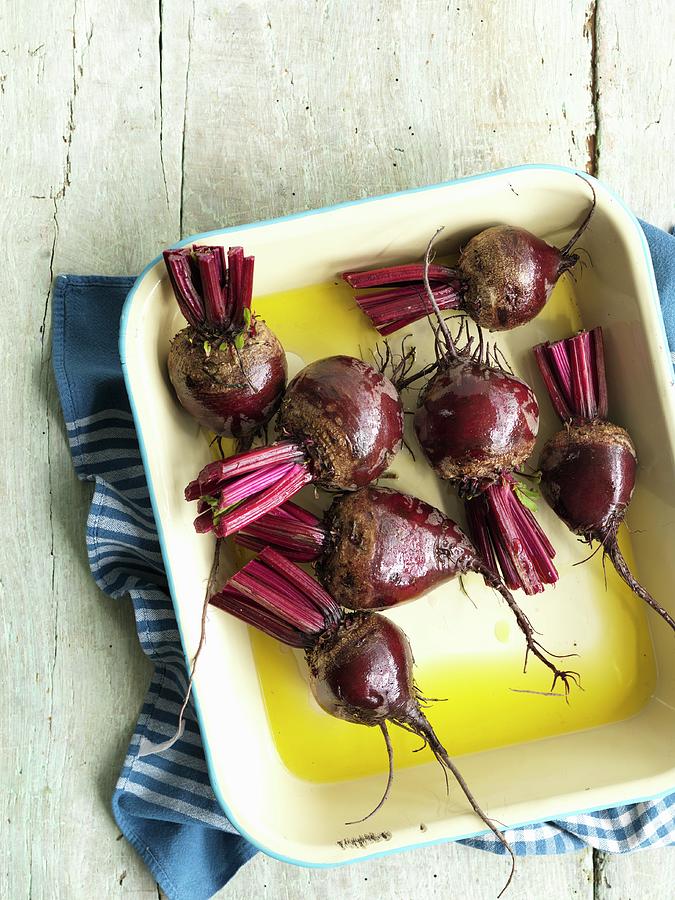 Beetroot In A Baking Dish With Oil Photograph by Jonathan Gregson