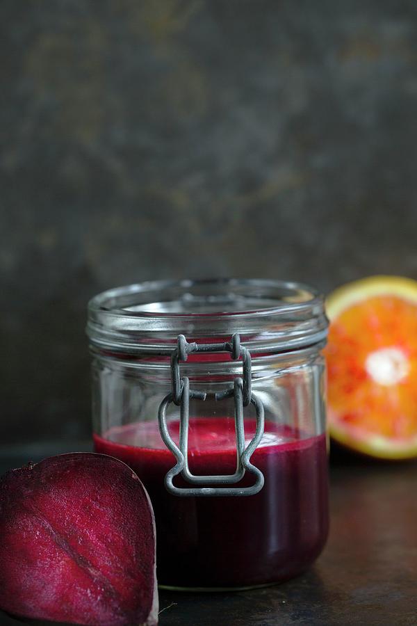 Beetroot Juice With Blood Orange In A Flip-top Jar Photograph by Tina Engel