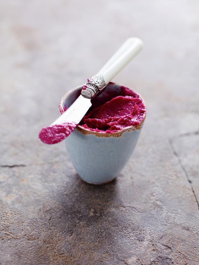 Beetroot Spread In A Small Bowl With A Knife Photograph by Oliver Brachat
