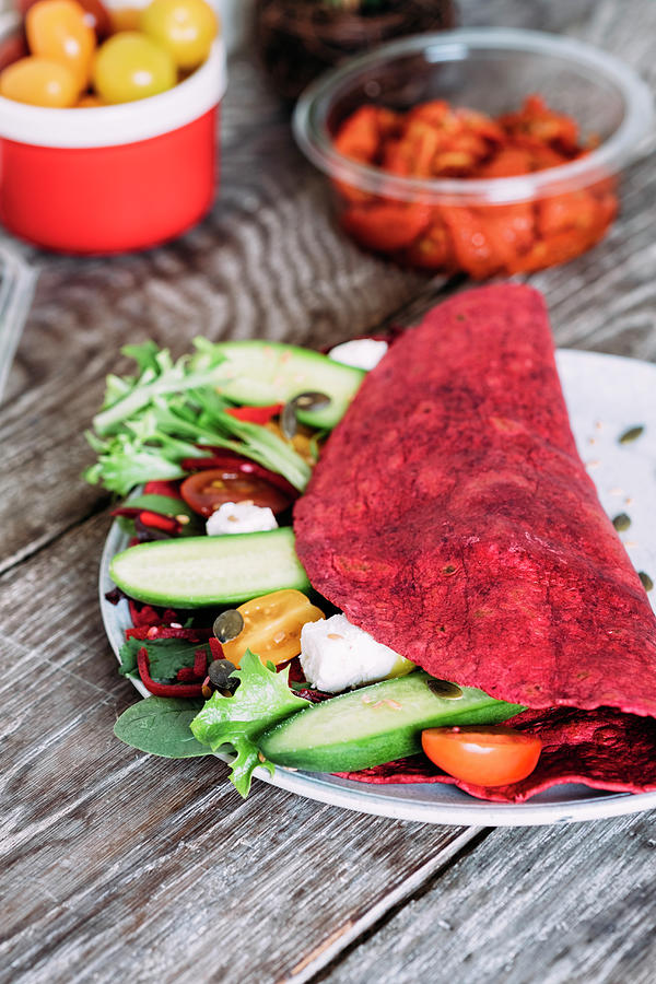 Beetroot Wrap With Semi-dried Tomatoes, Greek Feta, Cucumbers, Cherry Tomatoes And Salad Photograph by Adrian Britton