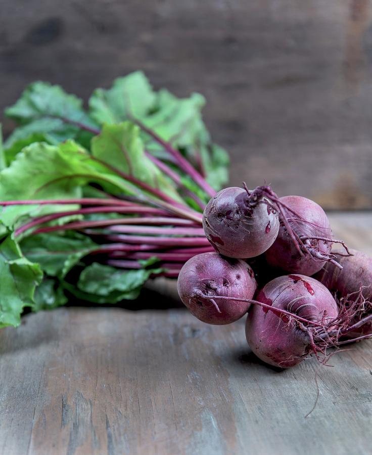 Beetroots With Leaves On A Wooden Surface Photograph by Angelika Grossmann