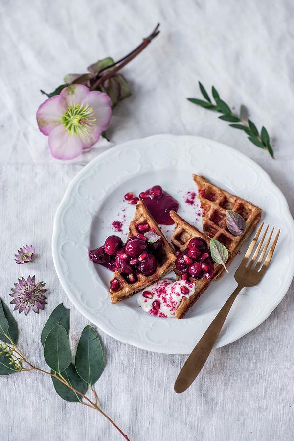 Belgian Spelt Waffles With Warm Cherries, Cranberries, Pomegranate Seeds And Christmas Roses Photograph by Carolin Strothe