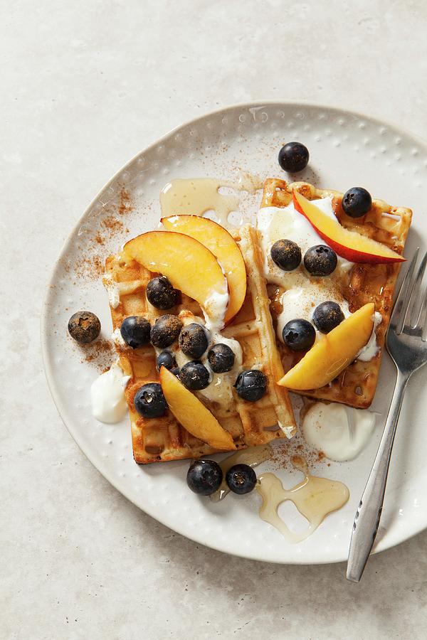 Belgian Waffles With Yoghurt, Honey, Blueberries And Peach Wedges Photograph by Stacy Grant