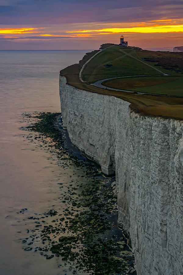 Belle Tout lighthouse after sunset at Seven Sisters cliffs in England. Photograph by George Afostovremea