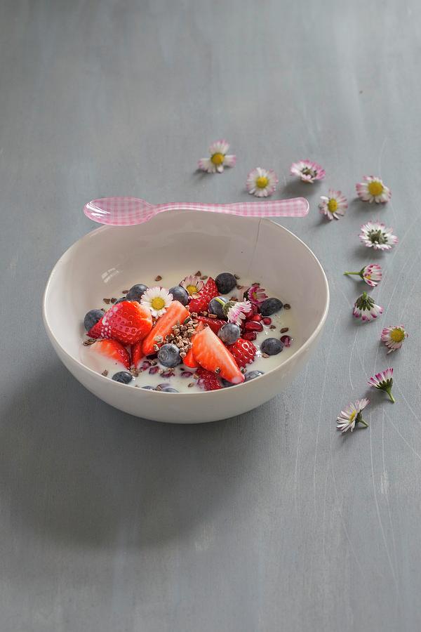 Berries With Yoghurt In A White Porcelain Bowl With Cocoa Nibs, A Pink Spoon And Daisies Photograph by Tina Engel