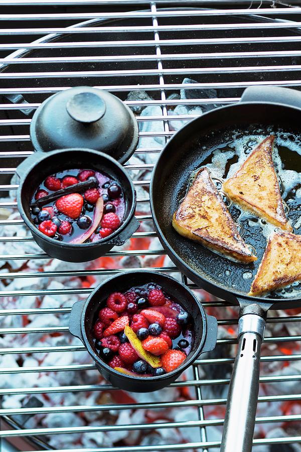Berry Compote In Small Pots And French Toast In A Pan On A Barbecue Photograph by Jalag / Wolfgang Schardt