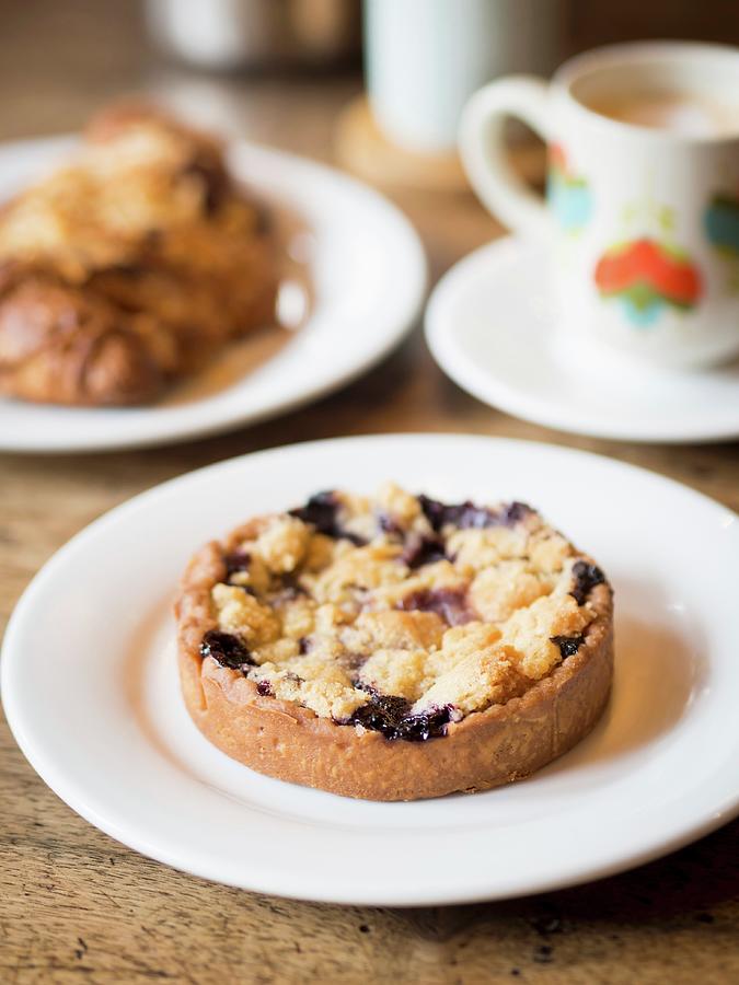 Berry Crumble Tartlet With A Cup Of Coffee In A French Caf Photograph by Magdalena Paluchowska