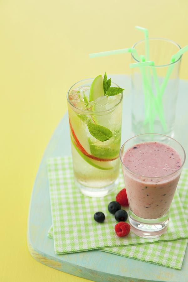 Berry Smoothie And A Sparkling Apple And Mint Drink Photograph by Geoff Fenney