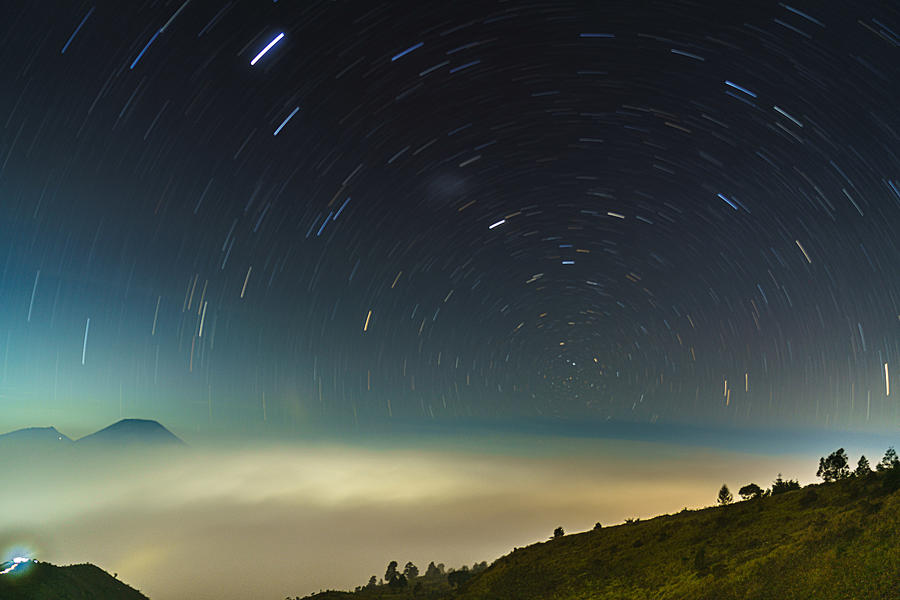Between Mountains Stars And Fog Photograph by Evi Soedarsono