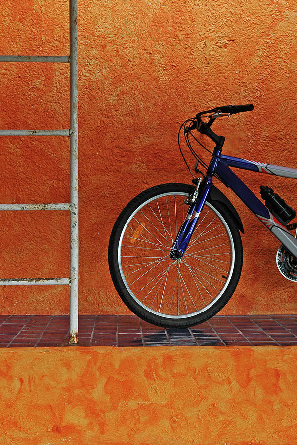 Bicycle Against Orange Wall, Vertical Photograph by Dlewis33