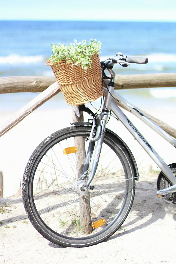 Bicycle Leaning Against Wooden Fence On Beach Photograph by Sylvia E.k Photography