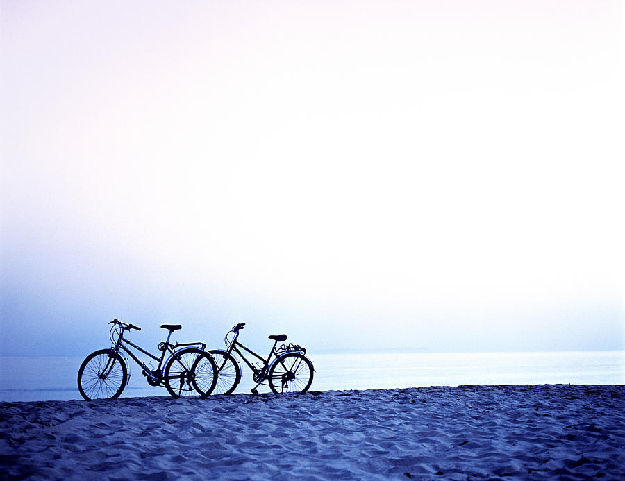 Bicycles On Beach Photograph by Martin Barraud