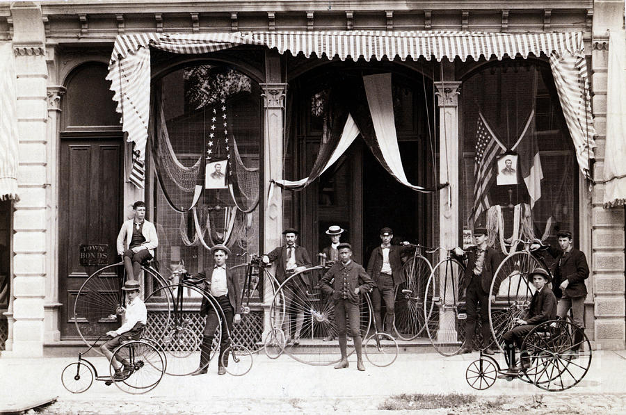 Bicyclists Posed In Front Of Draped Buil Photograph by Bettmann
