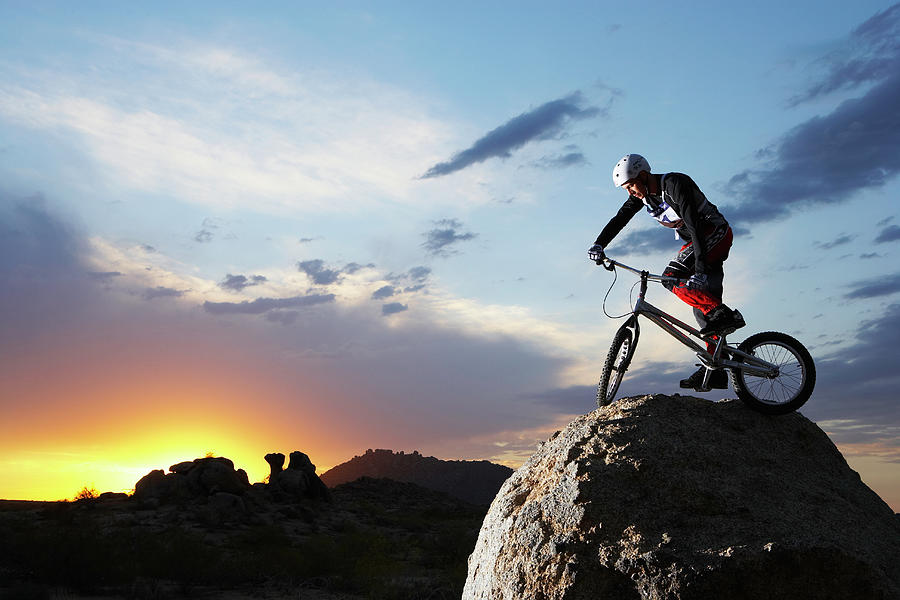 Bike Rider Balancing On Rock Boulder Photograph by Thomas Northcut
