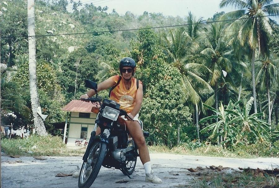 Biking thru Penang Photograph by Roger Swezey