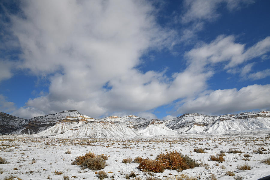 Billowing Clouds over Snow Covered Book Cliffs Photograph by Ray Mathis