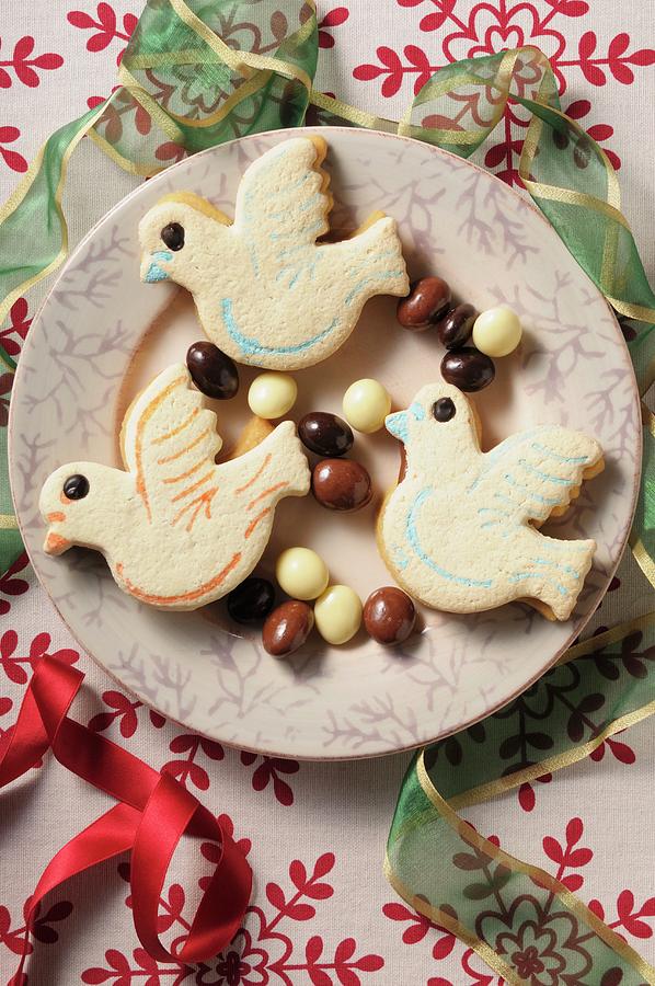 Bird Biscuits On A Plate With Chocolate-coated Nuts Photograph by Jean-christophe Riou
