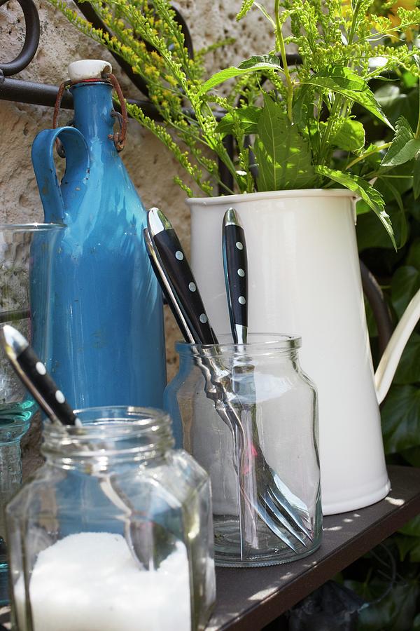 Bistro Cutlery On A Metal Shelf Against The Wall Of A House Photograph by Jalag / Olaf Szczepaniak